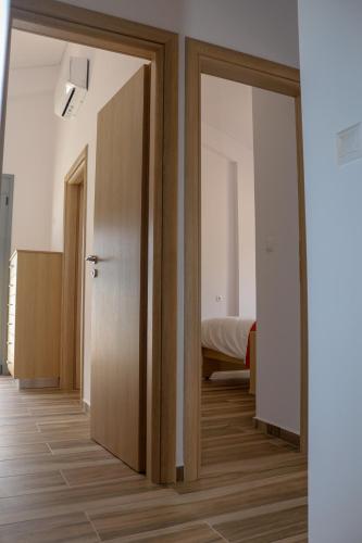a room with a door leading to a bedroom at ALTAVILLAS maisonettes in Kakí Vígla