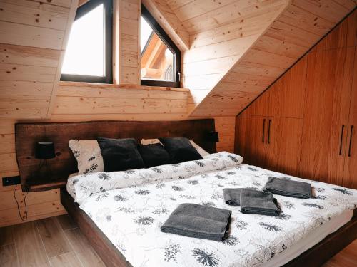 a bedroom with a bed in a wooden cabin at Grand Chalet Donovaly in Donovaly
