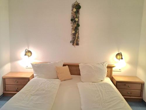 a bedroom with two beds and two lights on the wall at Bäuerlehof in Seebach