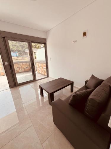a living room with a couch and a table at ALTAVILLAS maisonettes in Kakí Vígla