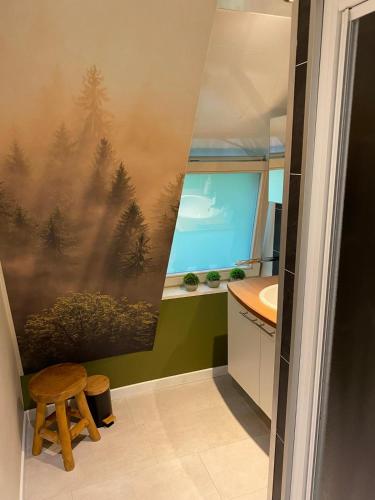 a bathroom with a painting of trees on the wall at Sunclass Durbuy Chalet 98 Woody in Durbuy