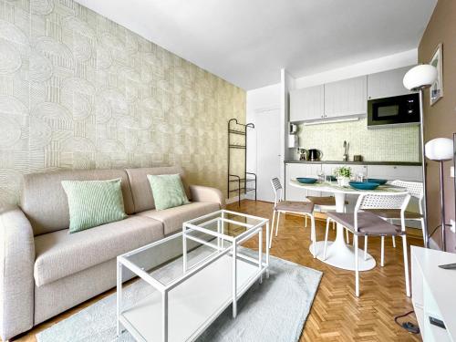 un salon avec un canapé et une table dans l'établissement Appartement Cosy 2P- Trocadero La Muette, à Paris