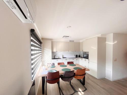 a kitchen and dining room with a table and chairs at Lindehoeve in Heusden - Zolder