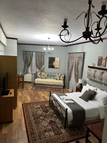 a bedroom with a bed and a living room at George Room 2 in Arachova