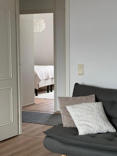 a living room with a couch and a bedroom at Arctic Jaakko Suite in Rovaniemi