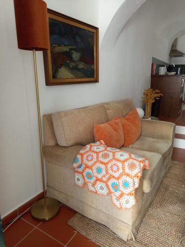a living room with a couch with pillows on it at TI8-Travessa das Invernas 8 in Évora