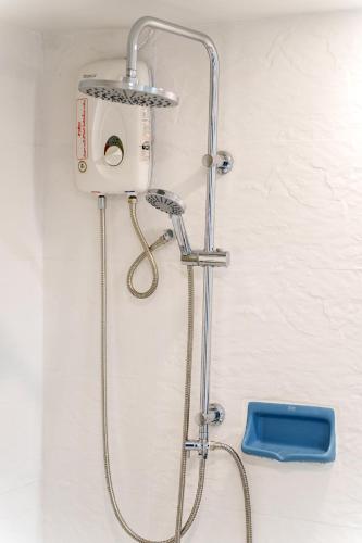 a shower with a shower head in a bathroom at Bang Saen Royal Beach by Sea view Bang Saen in Ban Laem Thaen