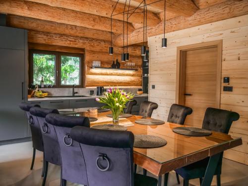 a dining room with a wooden table and chairs at Grand Chalet Donovaly in Donovaly