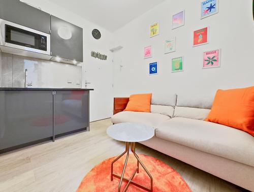 un salon avec un canapé et une table dans l'établissement Charmant studio 2P - 5' Tour Eiffel, à Paris