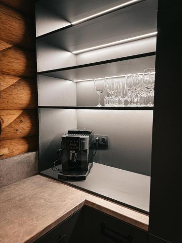 a kitchen with wine glasses on a shelf at Grand Chalet Donovaly in Donovaly