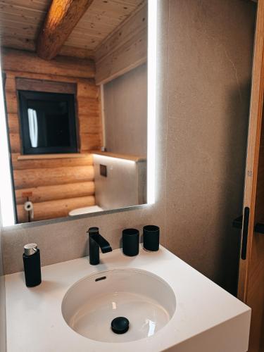 a bathroom with a sink and a mirror at Grand Chalet Donovaly in Donovaly
