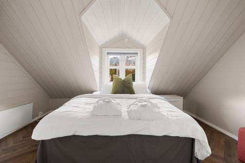 a bedroom with a bed with two pillows on it at Enter Tromsø - Exclusive Apartments in Tromsø