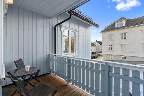 a patio with a table and chairs on a balcony at Enter Tromsø - Exclusive Apartments in Tromsø