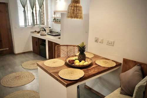 a kitchen with a table with a bowl of fruit on it at Antares Villa in Kiwengwa