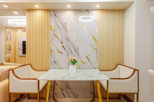 a dining room with a table and two chairs at The Manor at S Residences in Manila