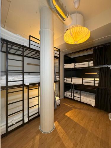 a room with four bunk beds and a column at Nomad City in Stockholm