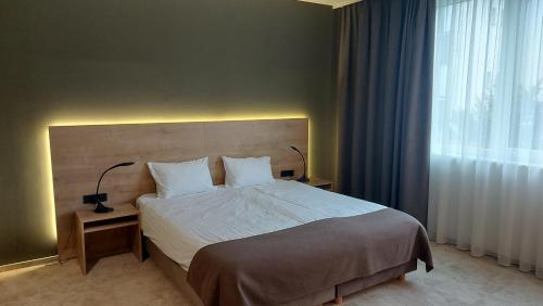 a bedroom with a large bed and a window at Hotel Prebold in Prebold