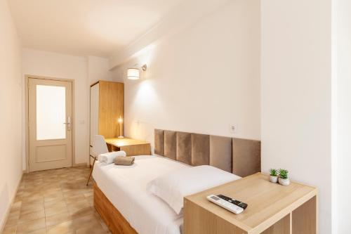 a bedroom with a bed and a desk in it at Rooms4you 2 in historic center of Braga in Braga