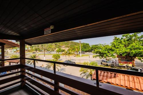 a balcony with a view of a parking lot at Tayá Hospedagens in Ubatuba