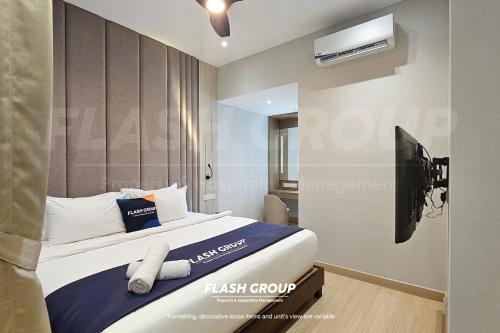 a bedroom with a bed and a tv in it at Windmill Upon Hills Premium Suites Genting Highland in Genting Highlands