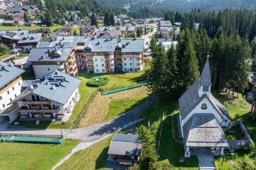 an aerial view of a village with houses and a church at Haus Mees in Königsleiten