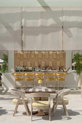 a lobby with a table and chairs and a bar at Delano Dubai at Bluewaters in Dubai