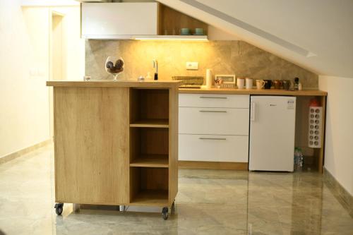 a kitchen with a counter and a refrigerator at New Moment Lux 2 in Žarkovo