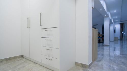 a white wall with drawers in a hallway at New Moment Lux 2 in Žarkovo