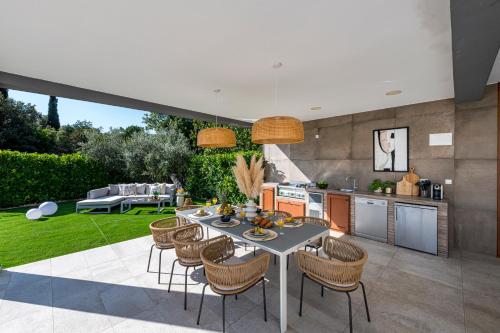 a kitchen and dining room with a table and chairs at Villa Jelena in Mlini