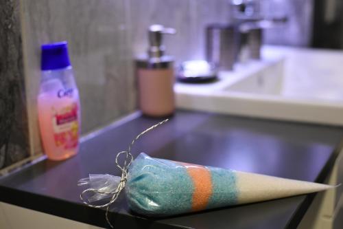 a bathroom counter with a towel and a bottle of soap at New Moment Lux 2 in Žarkovo