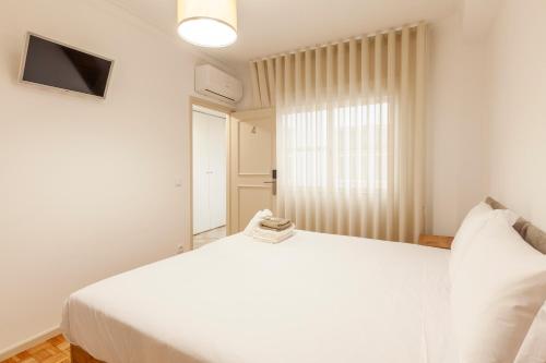 Ένα ή περισσότερα κρεβάτια σε δωμάτιο στο Rooms4you 2 in historic center of Braga
