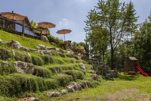 a set of stone steps with umbrellas on a hill at AGRITURISMO CA' FENILE in Alzano Lombardo