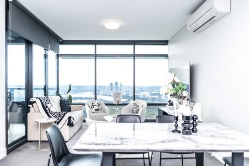 a dining room with a table and chairs at High-Rise with Park View in Sydney Olympic Park in Sydney