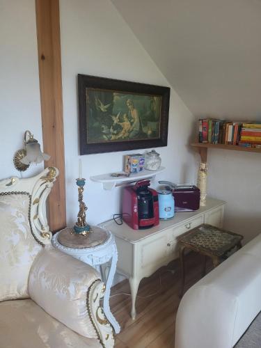 a living room with a white couch and a table at Ferienhaus Siegstrand in Mittelhof