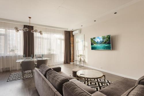 a living room with a couch and a table at Odesa Pearl Apartments in Odesa