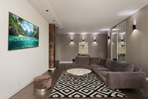a living room with a couch and a table at Odesa Pearl Apartments in Odesa