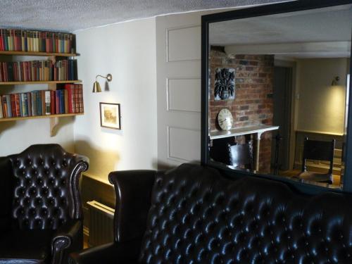 a living room with a couch and a mirror at The Black Bull Inn in Balsham