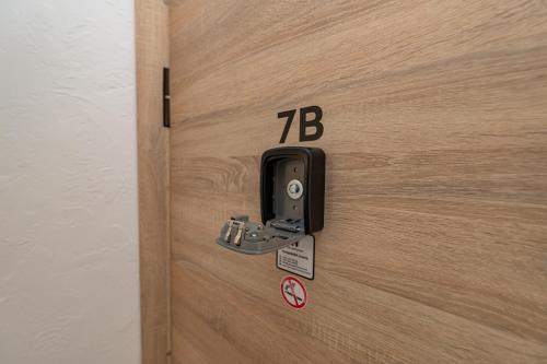 a close up of a wooden door with a phone on it at Pramonės Apartment #5 by PoloApartments in Kaunas