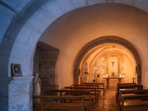 a church with a row of wooden pews and a altar at Abbaye de la Bussière in La Bussière-sur-Ouche