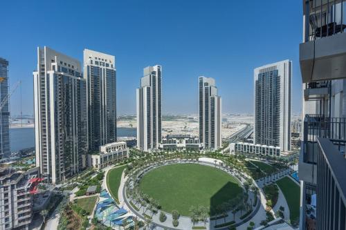 an aerial view of a city with tall buildings at Free housekeeping visits during your stay - StayShort - Captivating 1BR apartment in Dubai Creek Harbour in Dubai