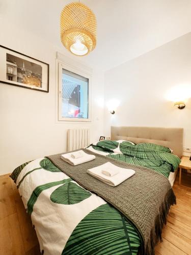 une chambre avec un lit avec deux serviettes dessus dans l'établissement Paris15 Convention - Garden in Paris Sweet Home, à Paris