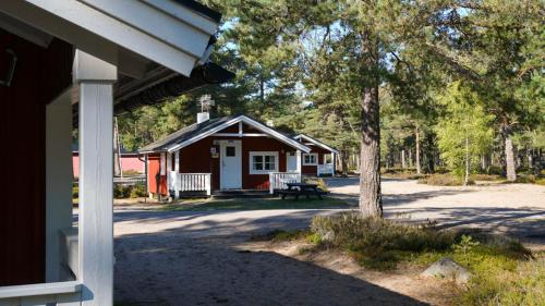 a cabin with a bench in front of it at Stenö Havsbad och Camping in Sandarne