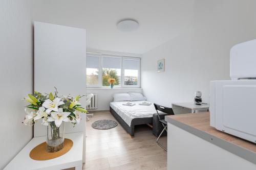 a room with a kitchen and a living room at Pramonės Apartment #8 by PoloApartments in Kaunas