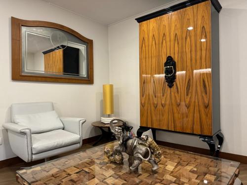 a living room with a chair and an elephant statue at Hotel Lino in Vigo