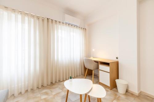 a room with a table and a chair and a desk at Rooms4you 1 in historic center of Braga in Braga