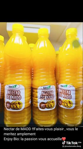 a group of bottles of orange juice in a refrigerator at Auberge Cœur Océan in Joal-Fadiout