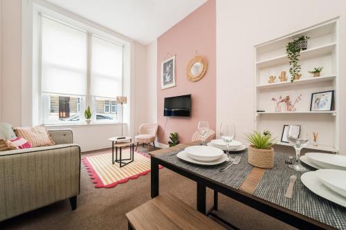 a living room with a table and a couch at 4 Beds - City Gateway Getaway with Free Parking in Glasgow