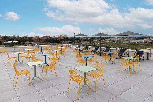 a group of tables and chairs on a roof at CX Milan NoM in Milan