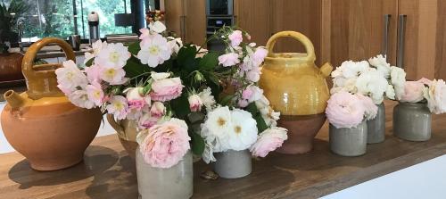 a group of vases filled with flowers on a table at Mas Notre Dame in Eygalières