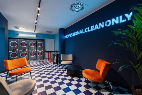 a dressing room with orange chairs and a blue wall at CX Milan NoM in Milan